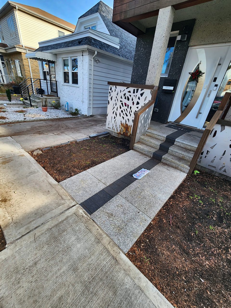 New concrete walkway at a home entry, 2024
