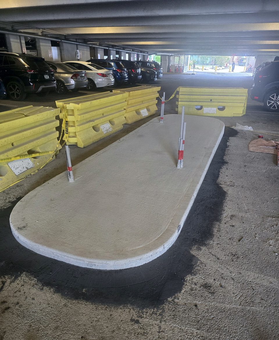 After: the finished equipment island under the garage deck, August 2026
