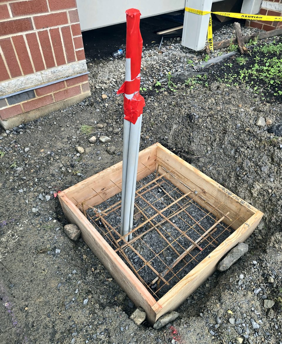 During: one of four equipment pads on grade, formed with rebar and conduit