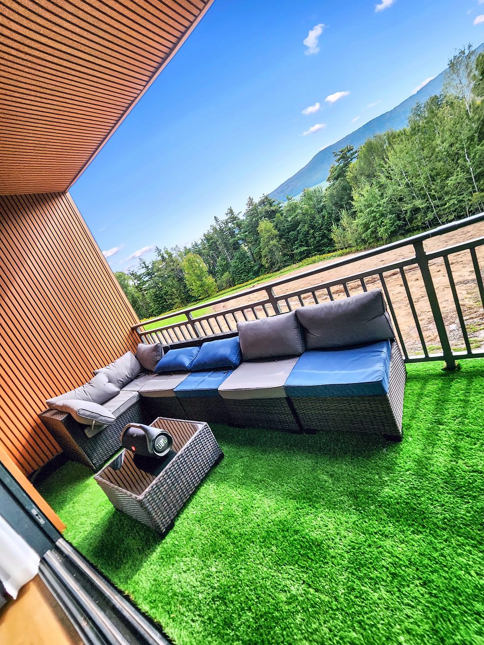 Covered balcony with a wood-slat ceiling
