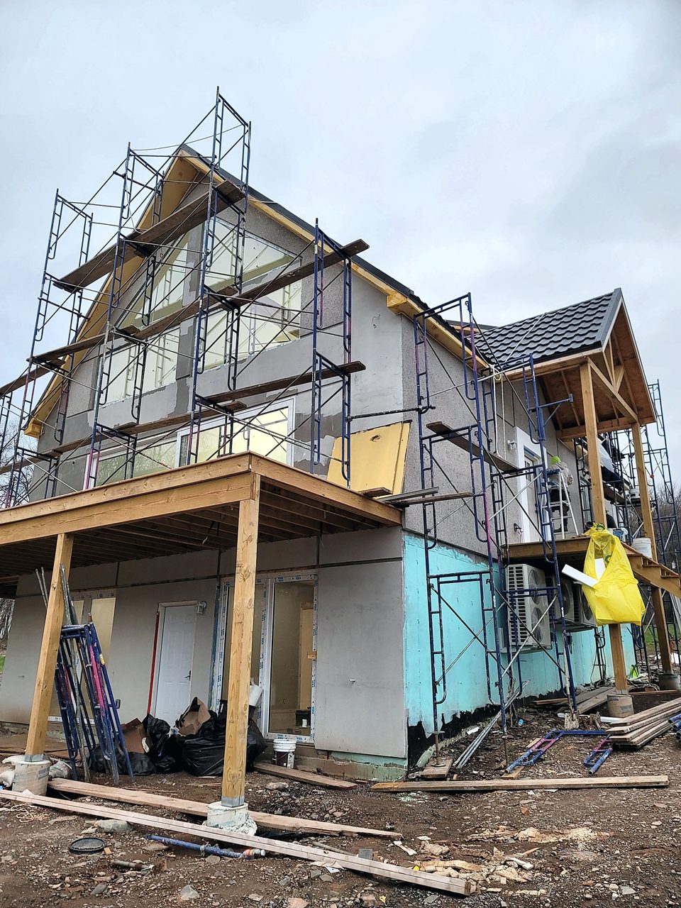 Stucco crew on scaffold at a new gable house, 2022