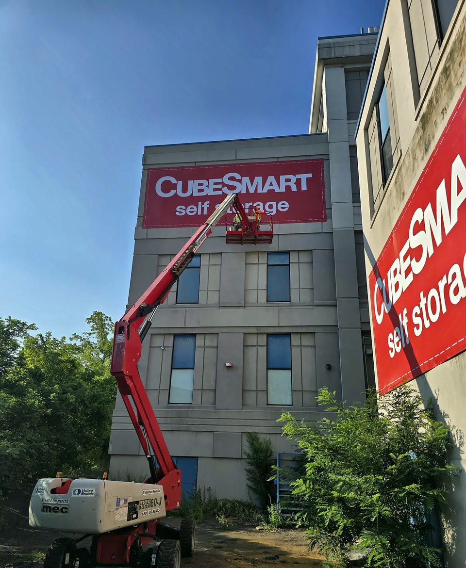 Self-storage conversion, Schenectady: boom-lift work at the signage elevation, August 2025