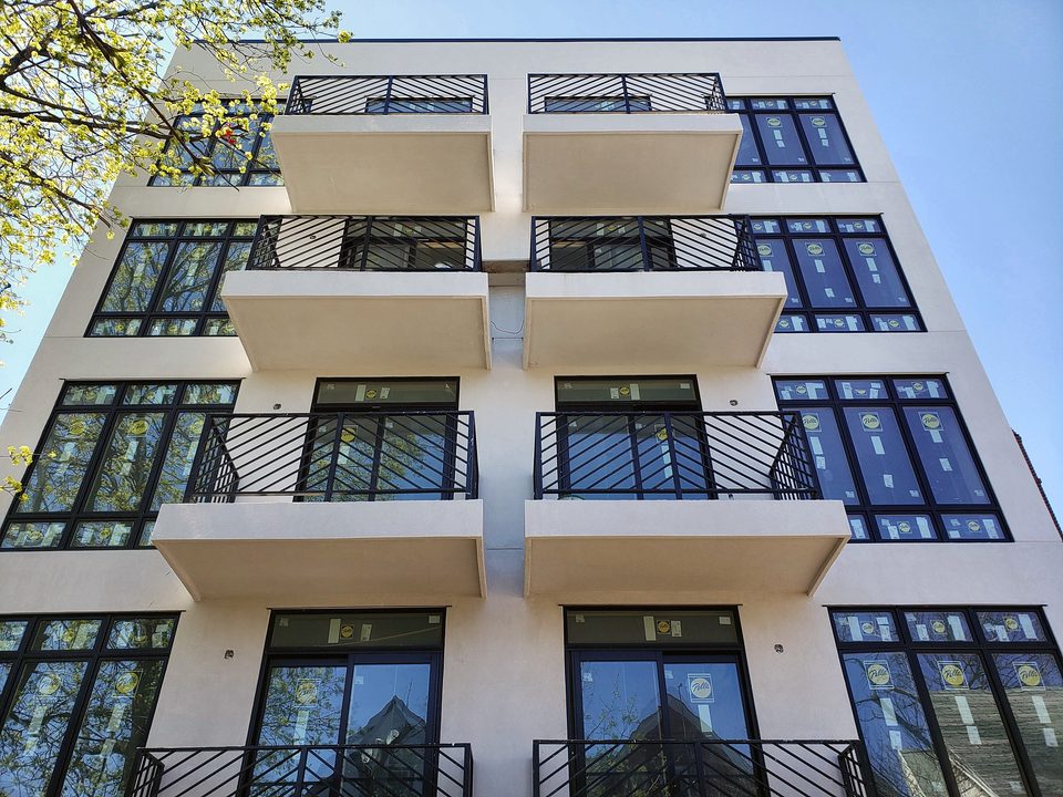 Modern white multifamily facade, 2019