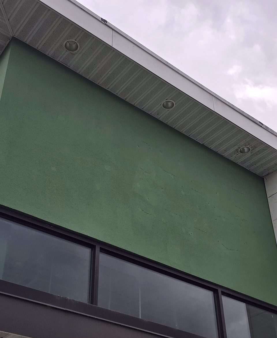 The green EIFS feature panel before re-coating