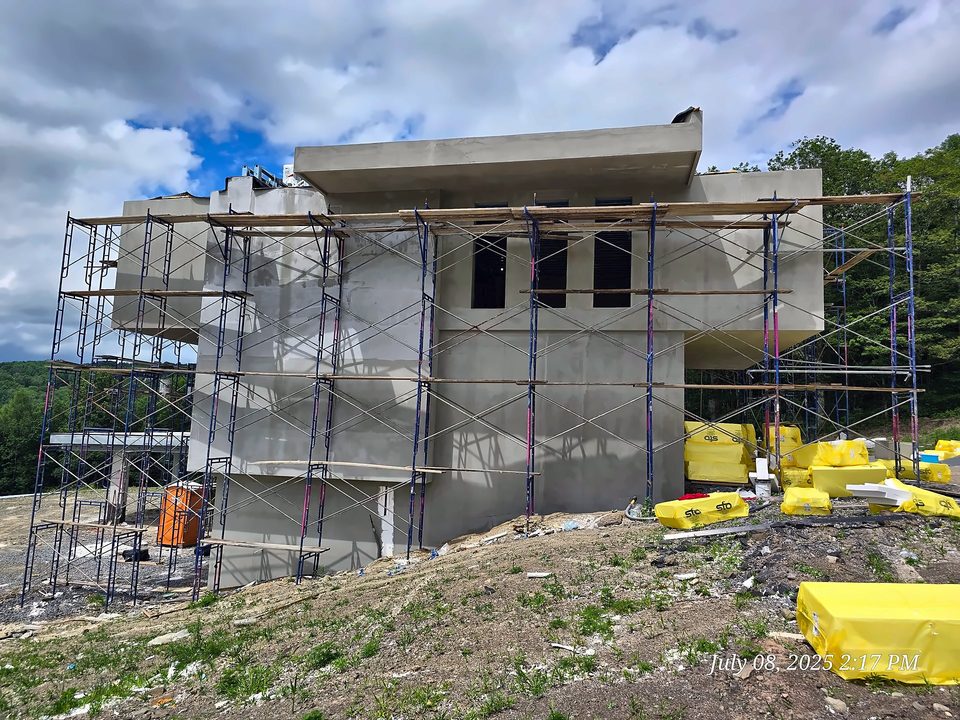 Steel Mountain Villa: EIFS basecoat stage from scaffold towers, summer 2025
