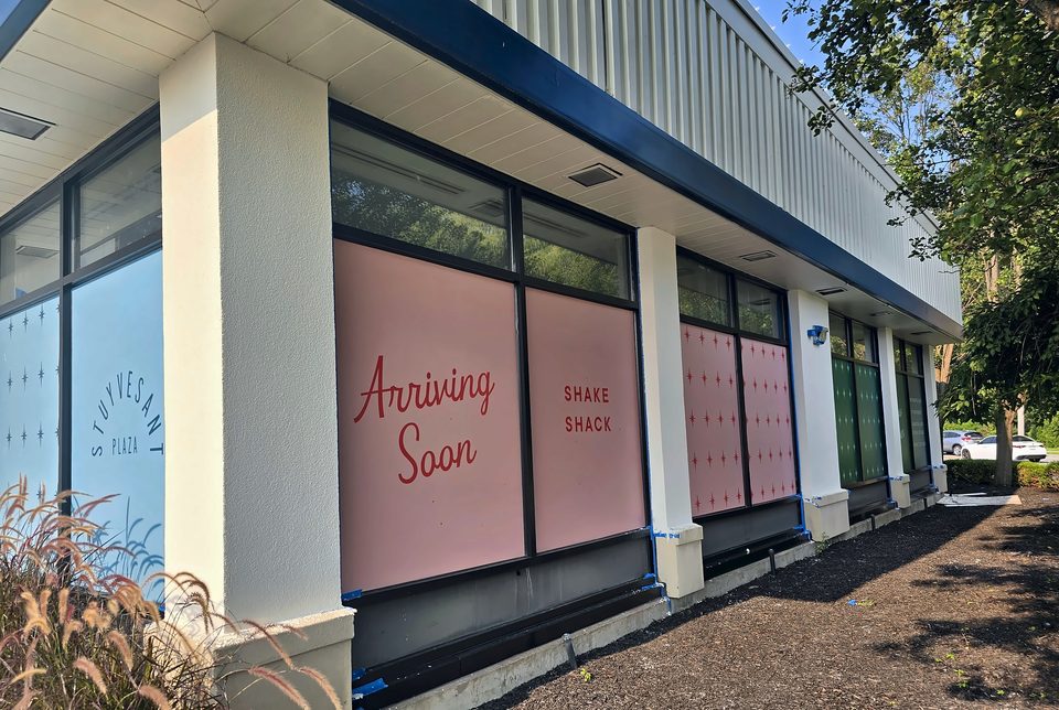 Storefront elevation at the plaza, August 2026