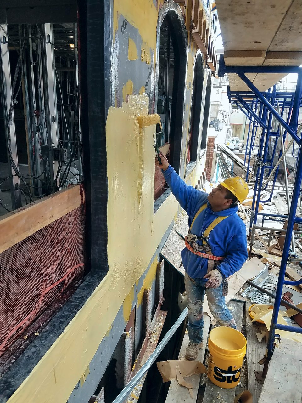 Stucco finish applied from scaffold, 2017