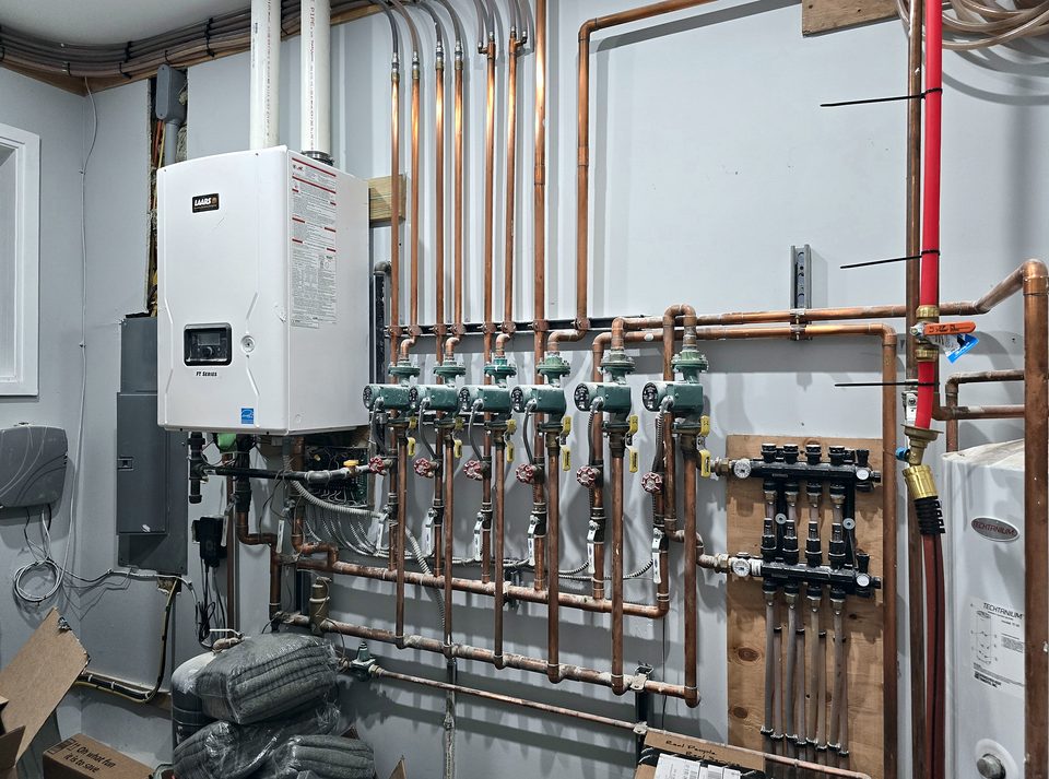 Finished boiler room with manifold piping, 2024