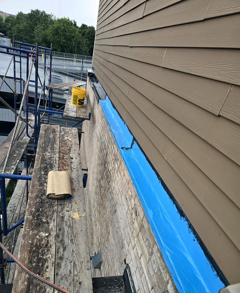 During: self-adhered membrane at the parapet from pipe scaffold, August 2026