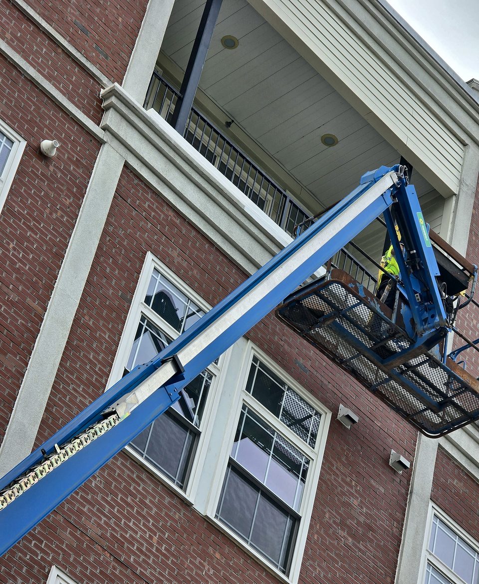 During: boom-lift access to the balcony underside, July 2026