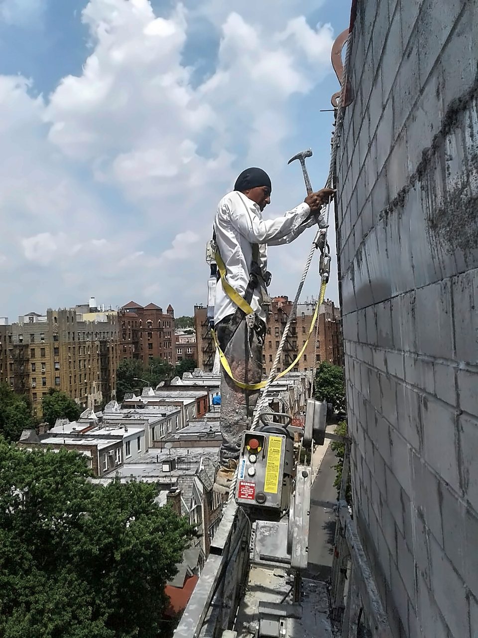 Facade repair from a swing stage, 2019