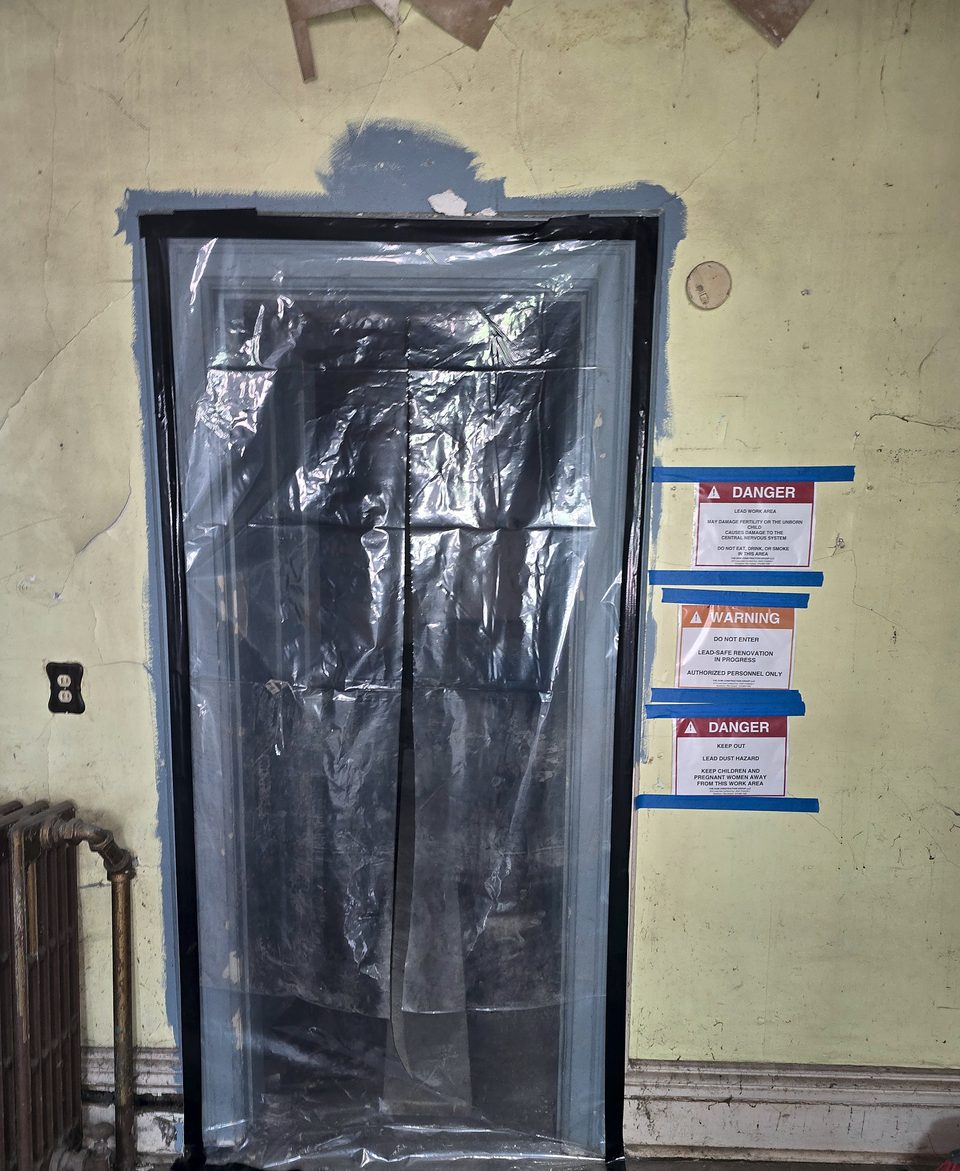 Lead-safe containment at an interior doorway (EPA RRP practices)