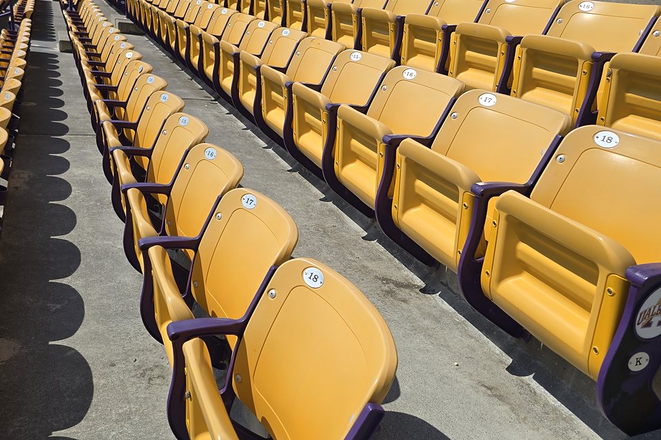 Before — faded, dull seat standards along the grandstand rows