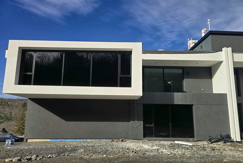 After: the finished two-tone EIFS envelope, November 2025