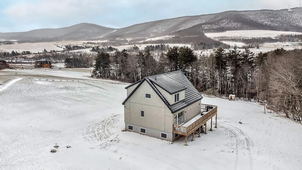 The same gable house from the air in winter — Stamford NY