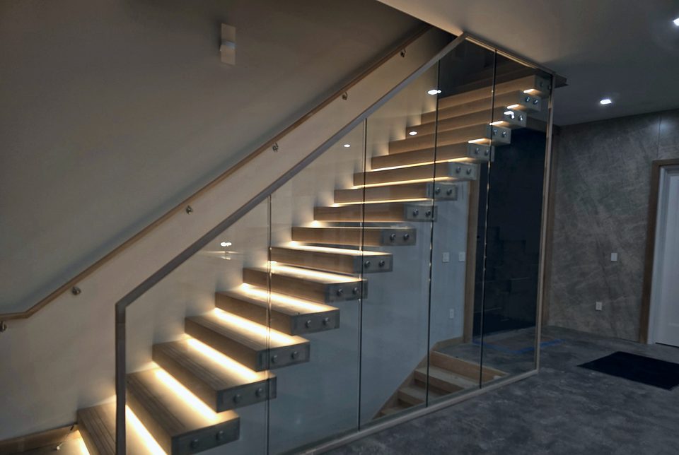 LED-lit floating stairs with glass railing, 2025