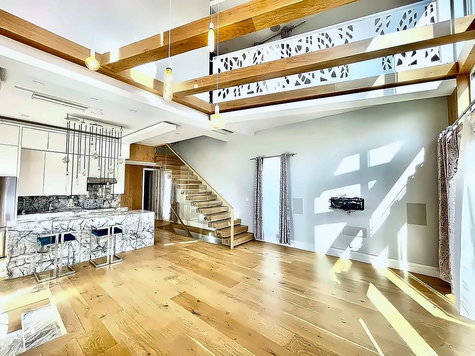 Open kitchen and living level with exposed timber beams