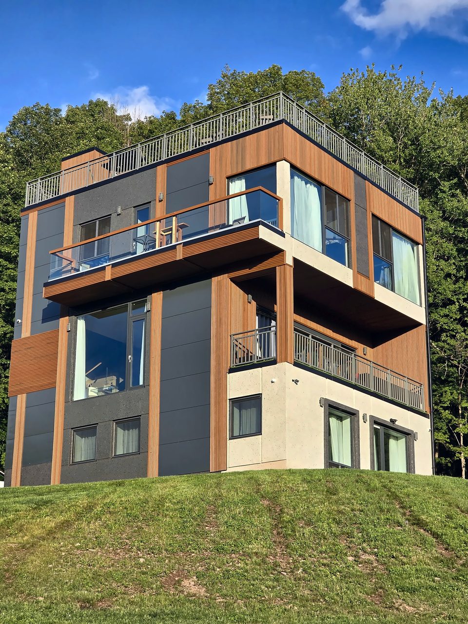 The finished house on its hillside, summer 2024
