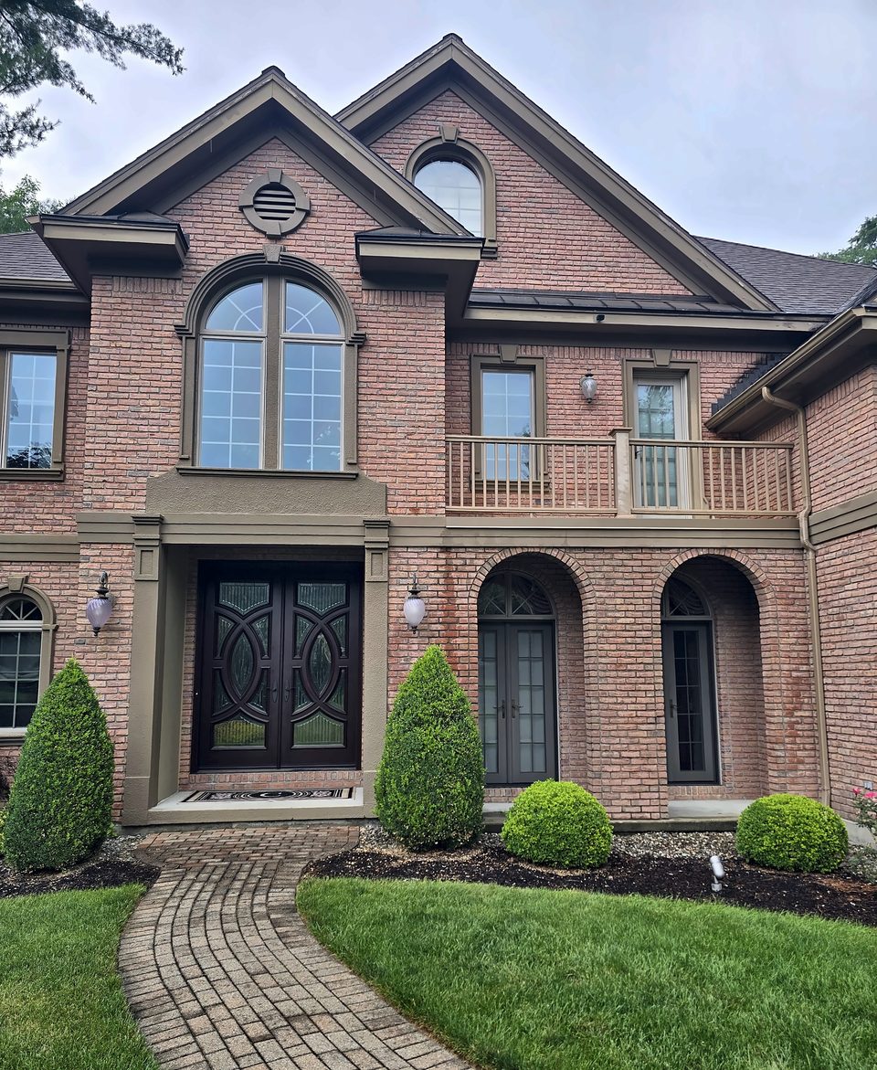 Schenectady NY — brick colonial after the entry and balcony restoration, July 2026