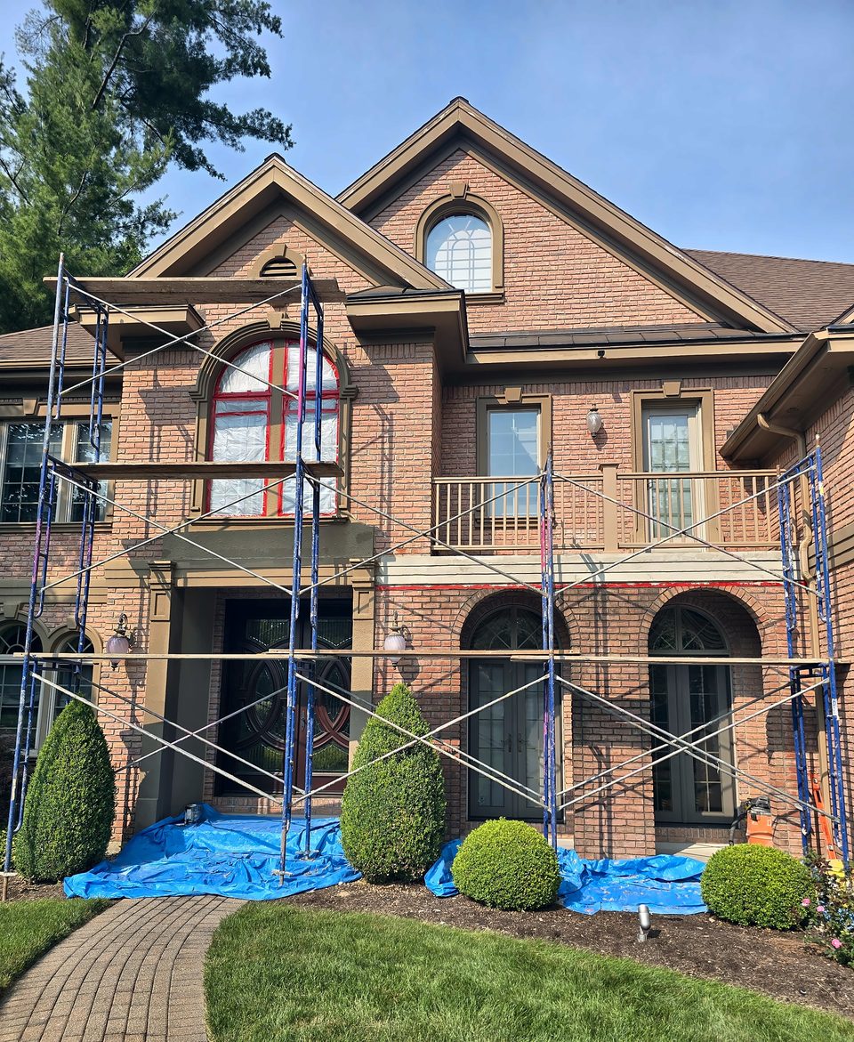 During: the front elevation under scaffold, mid-July 2026