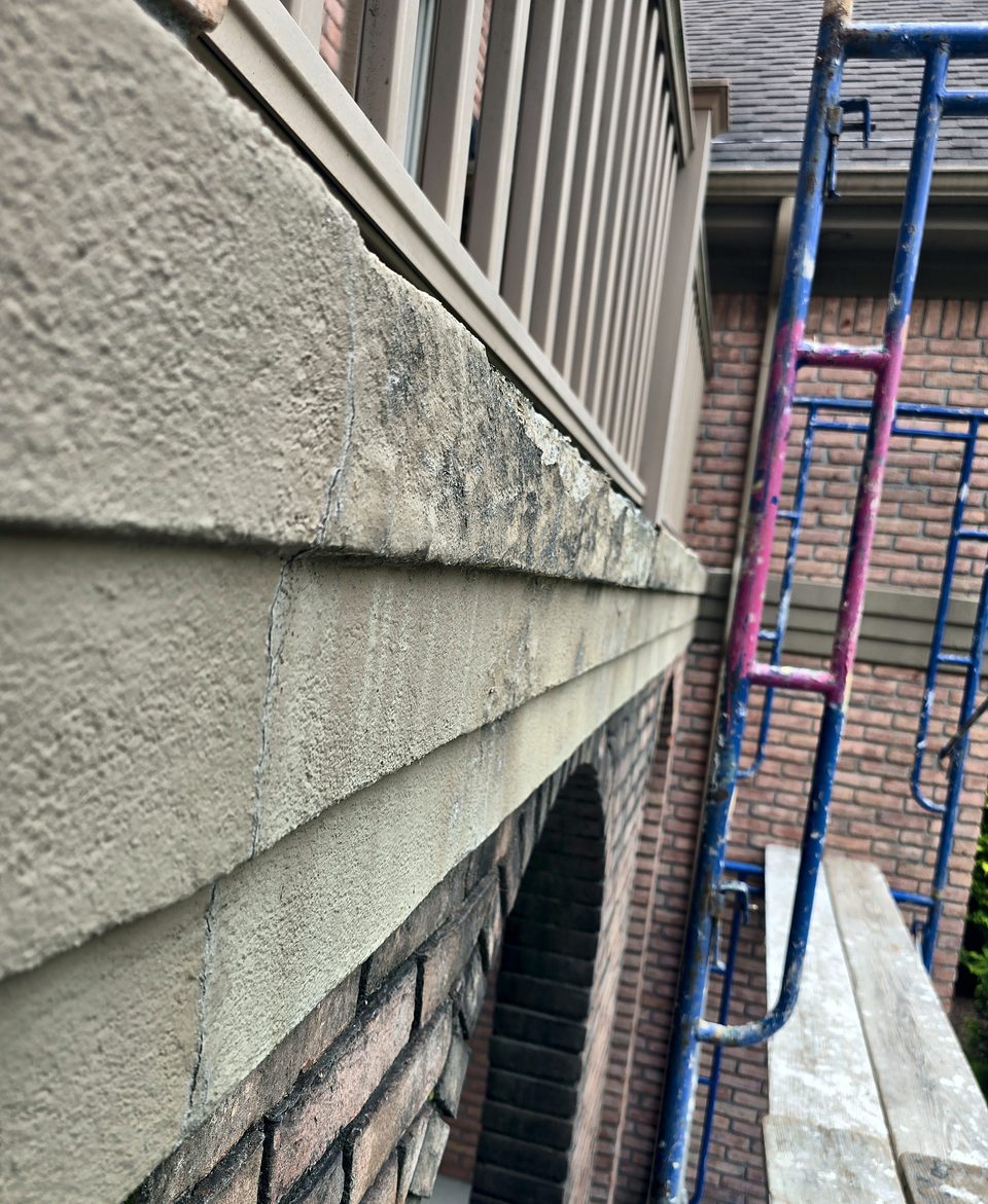 Before: the cracked, moisture-damaged EIFS band that let water in