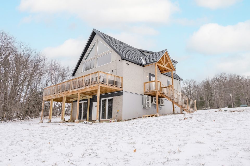 The gable house and wraparound deck in winter, February 2024