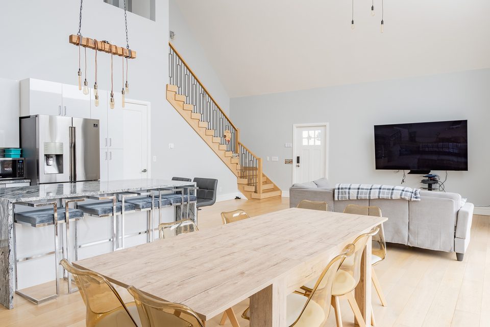 Kitchen, dining and stairs under the vaulted ceiling