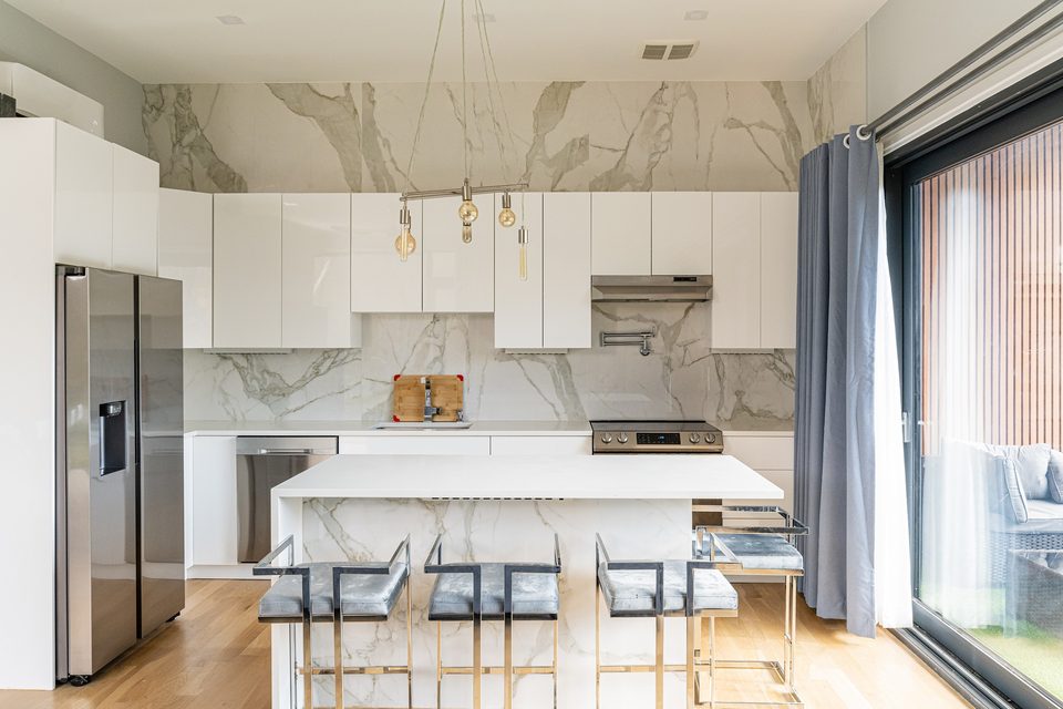 Kitchen with marble-look backsplash and island
