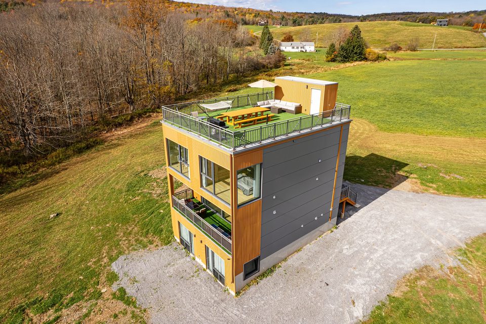 The finished house on its hillside, autumn 2023