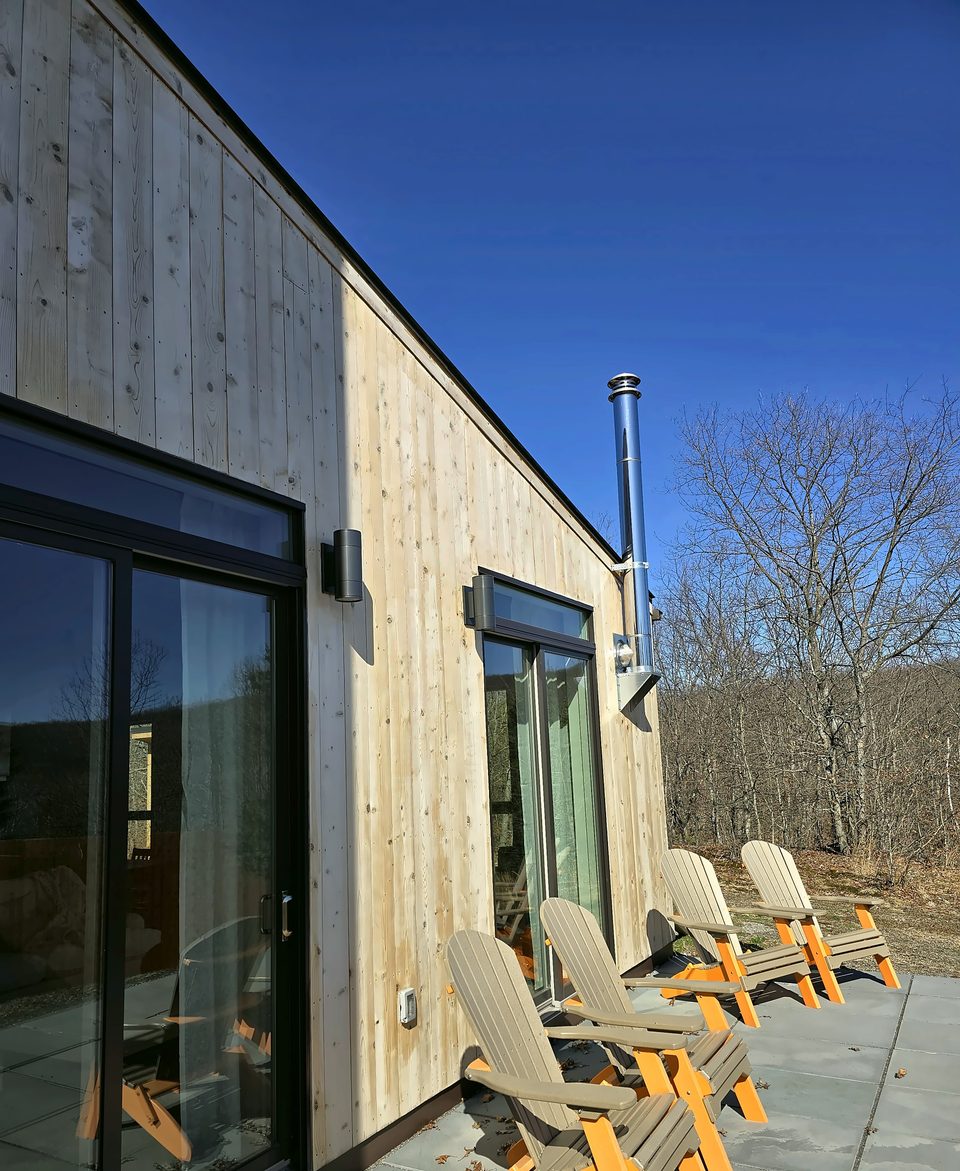 Wood siding and patio on a modern home, 2025